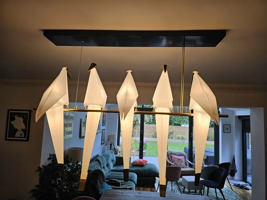 Illuminated pendant fittings above a dining table